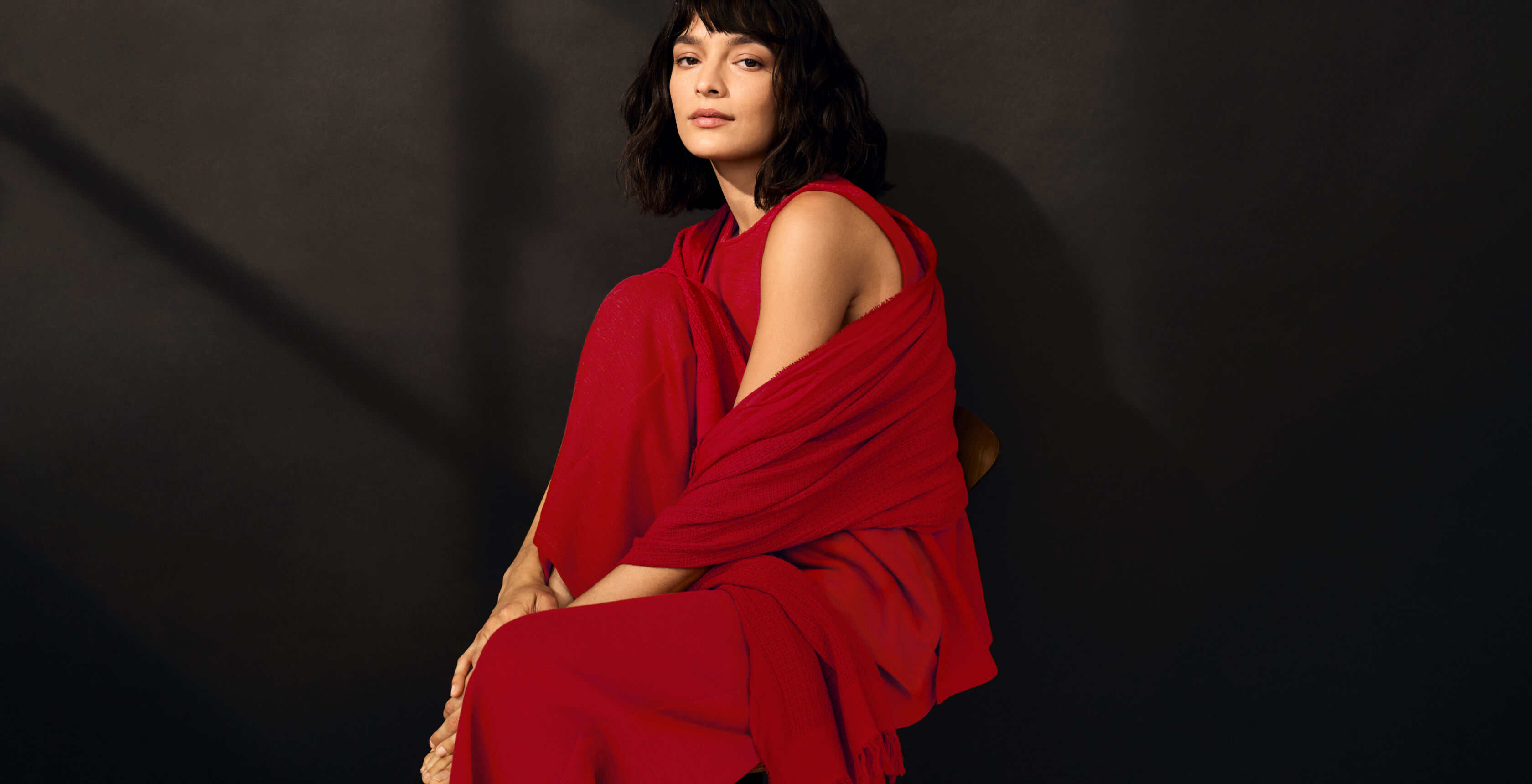 EILEEN FISHER model wearing a matching red outfit. EILEEN FISHER model wearing a matching red outfit.