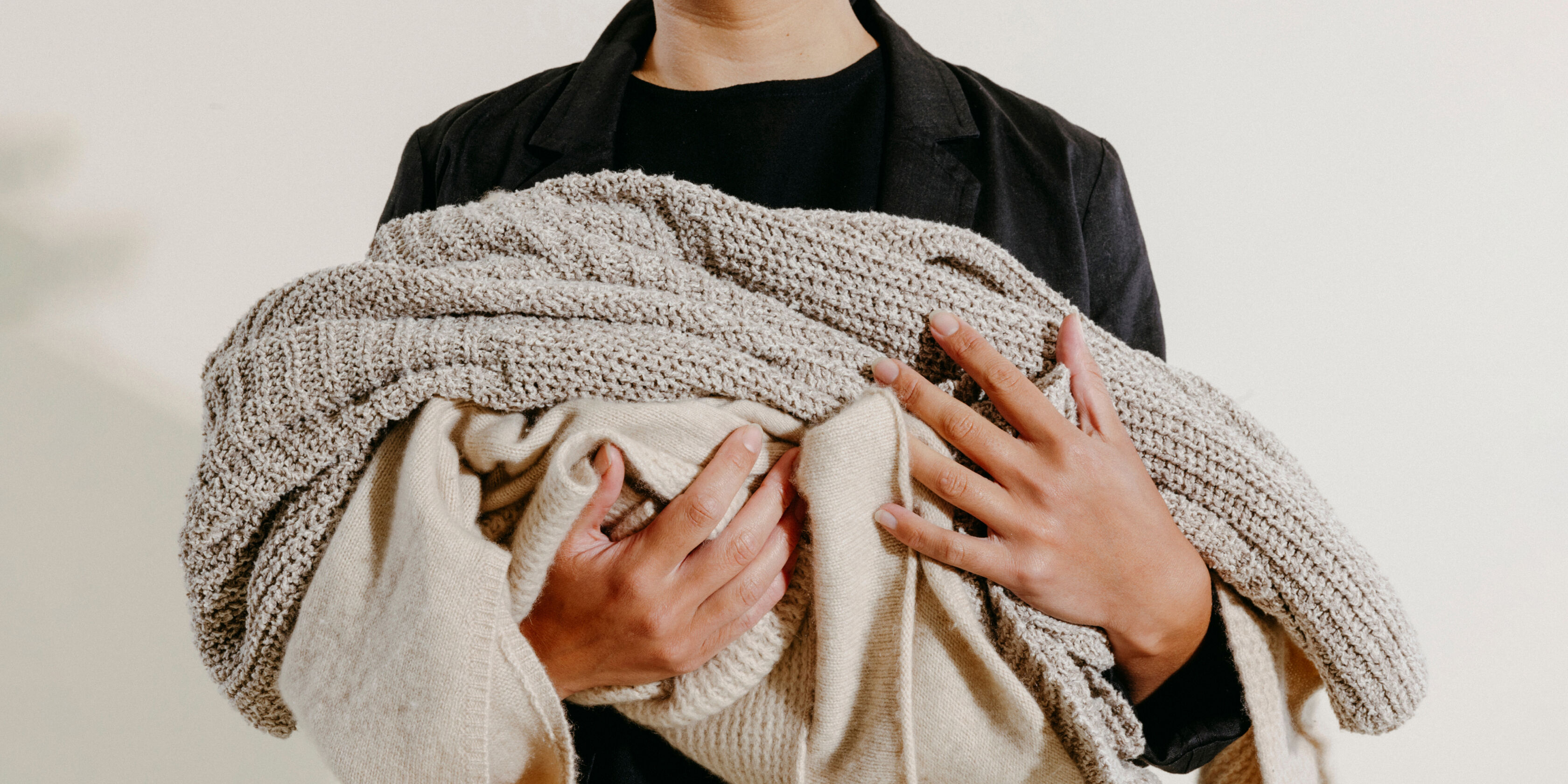 Model holding clothes from EILEEN FISHER's take-back program, Renew. Model holding clothes from EILEEN FISHER's take-back program, Renew.