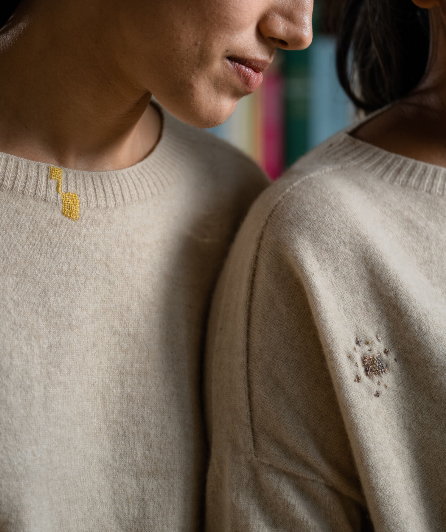 Women wearing mended sweaters. Women wearing mended sweaters.
