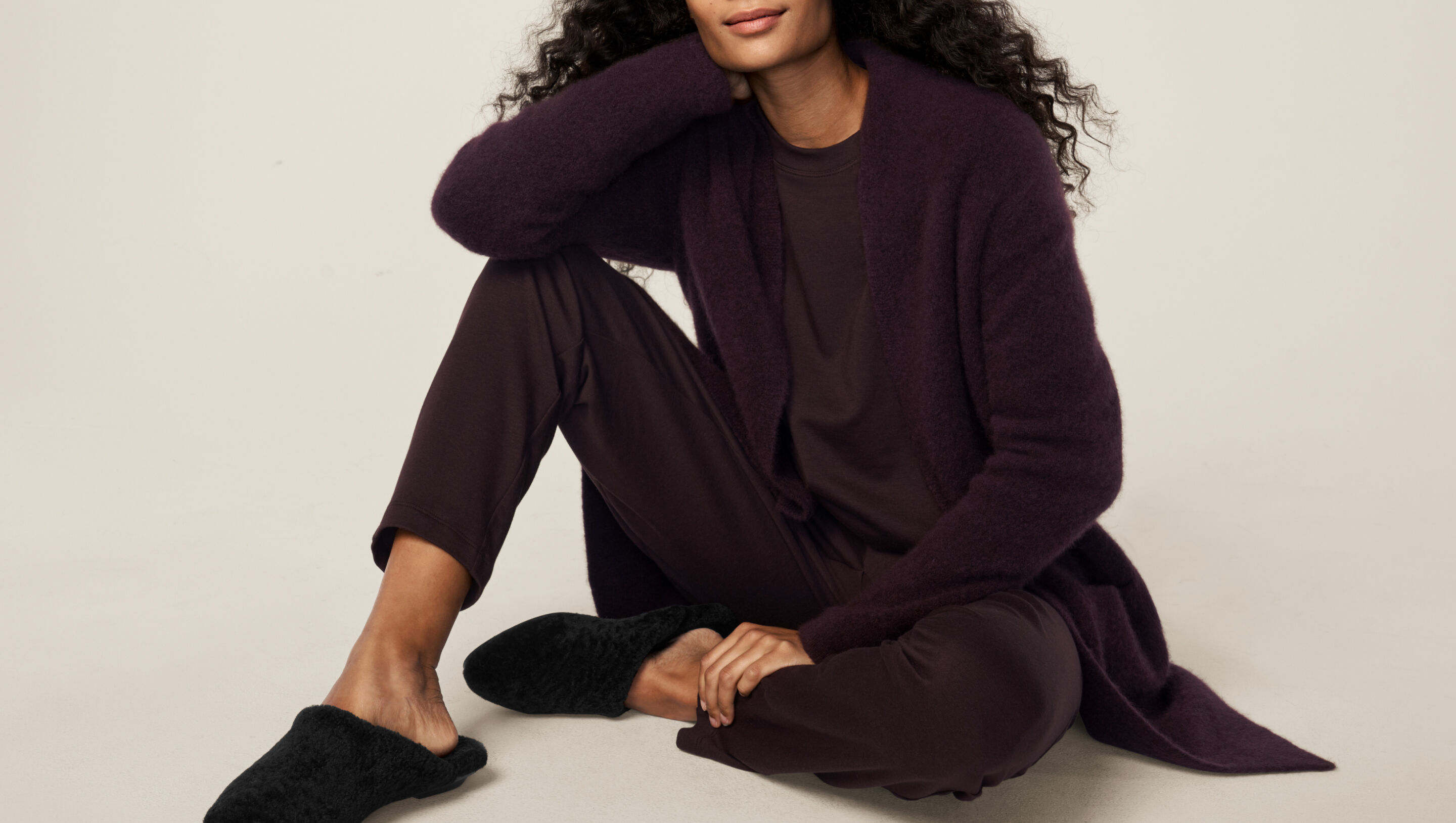 Seated woman dressed in matching outfit. Seated woman dressed in matching outfit.