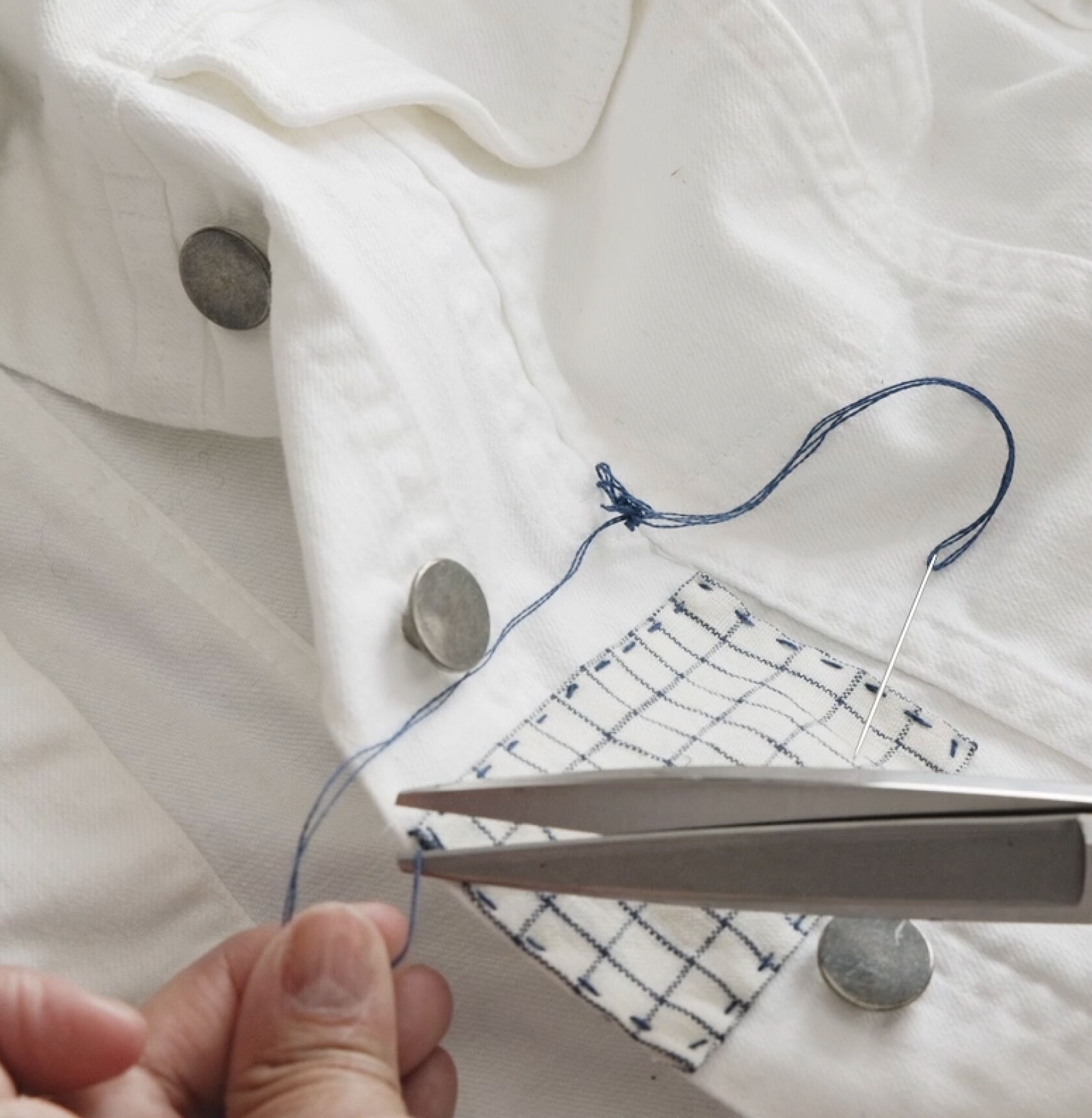 Trimming excess thread with scissors. Trimming excess thread with scissors.