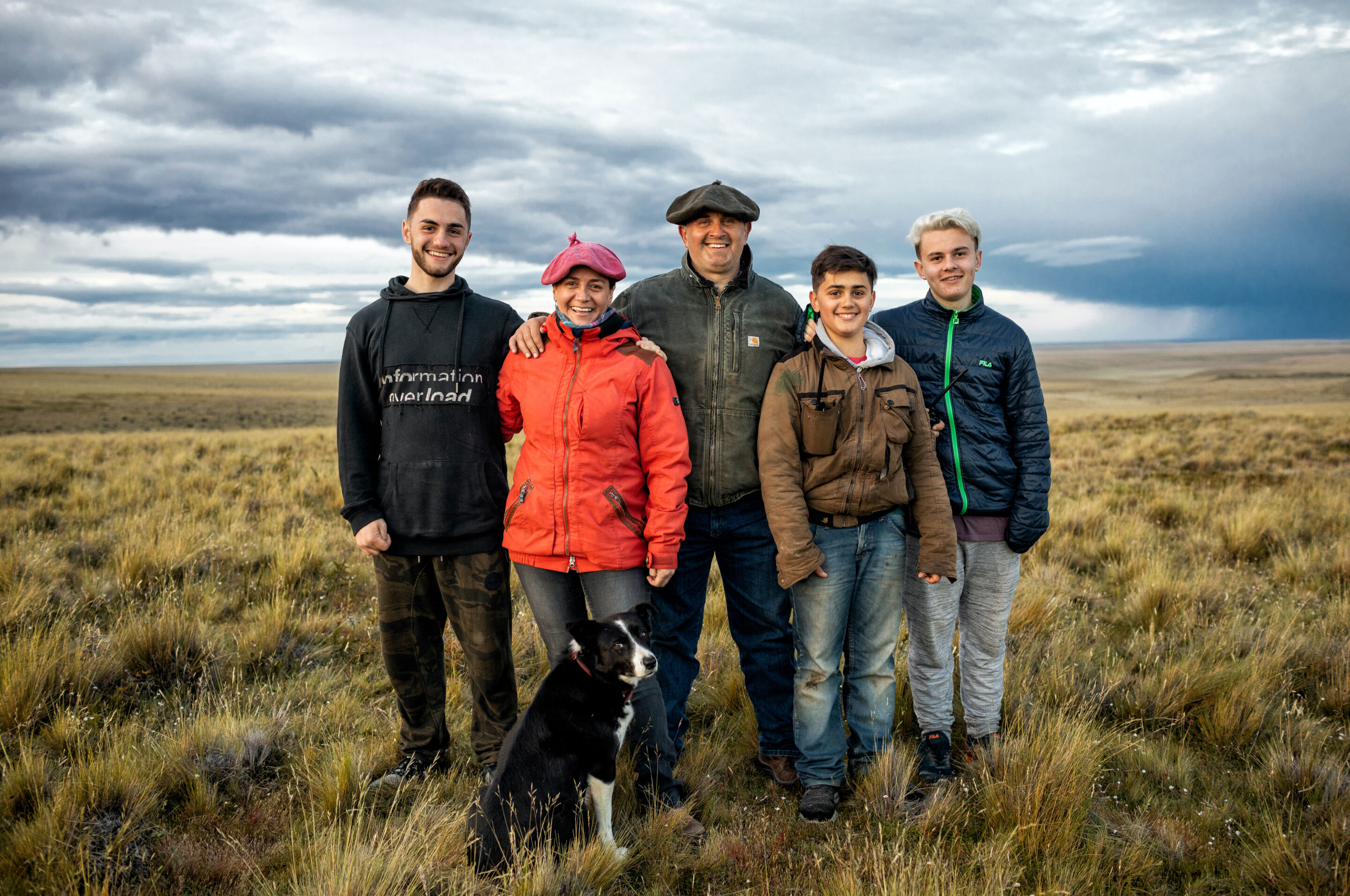 Family of regenerative wool farmers in a field. Family of regenerative wool farmers in a field.