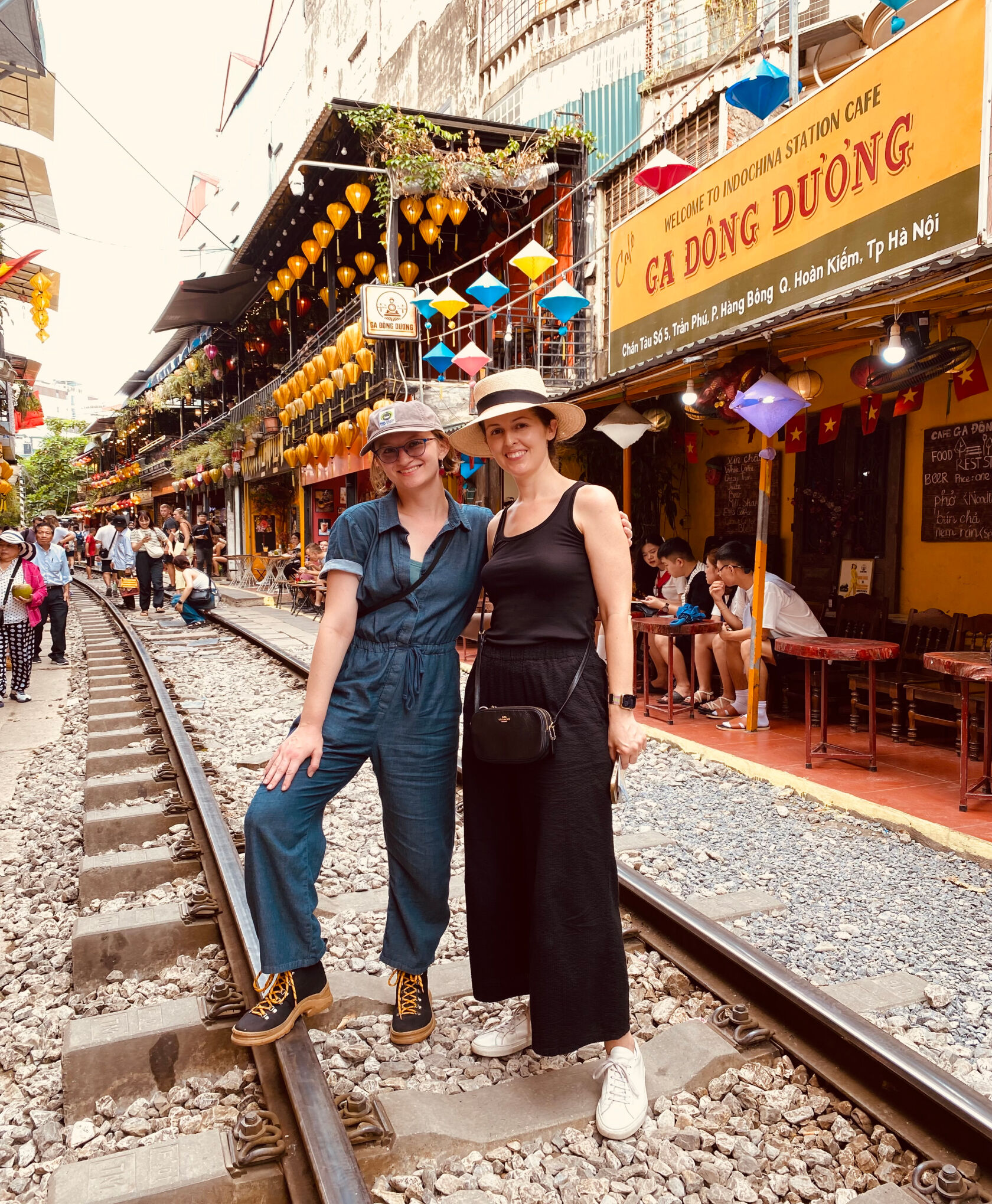 Two women posing at Train Street, a narrow alleyway in Hanoi. Two women posing at Train Street, a narrow alleyway in Hanoi.