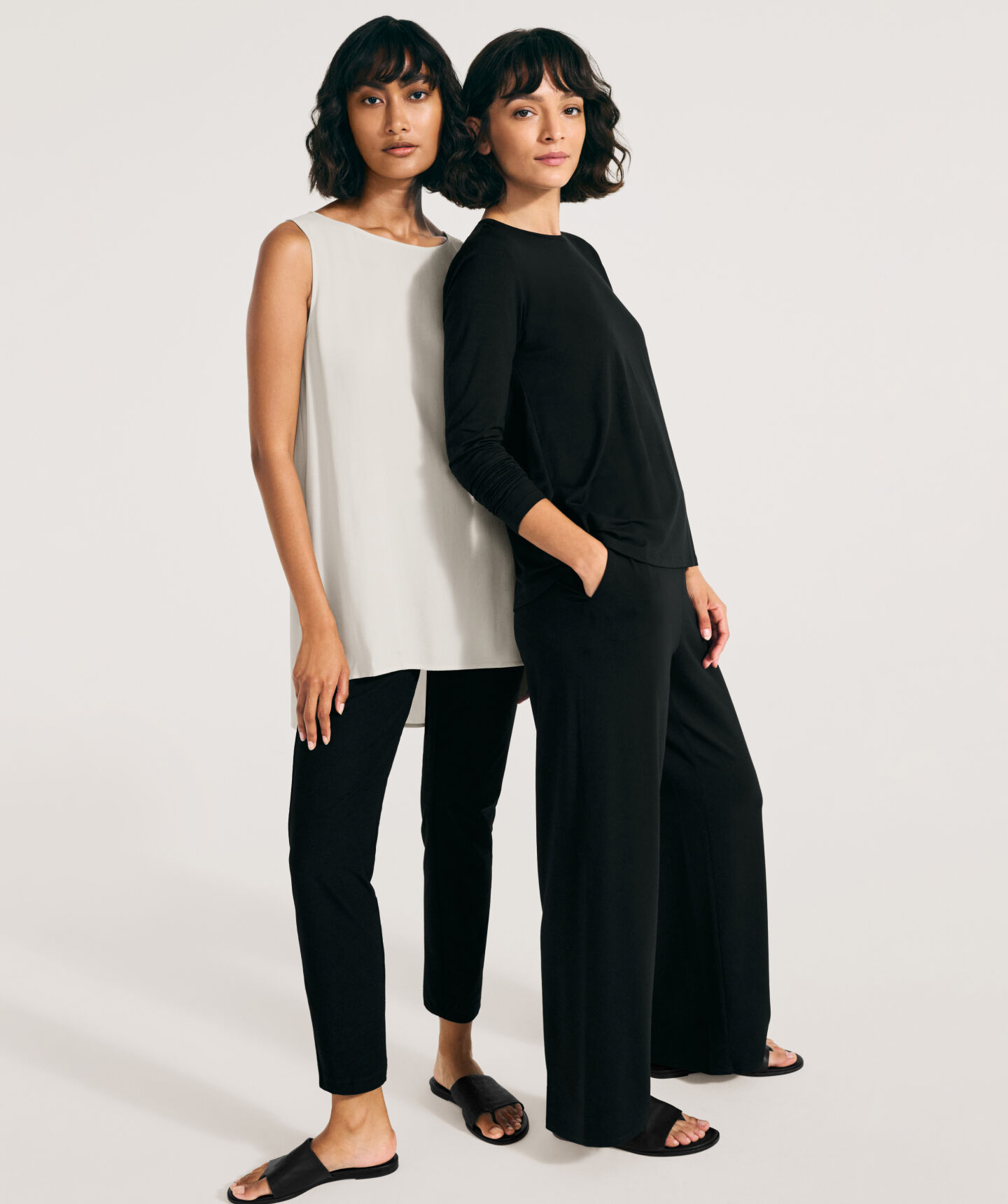 Two women wearing timeless clothing. Two women wearing timeless clothing.