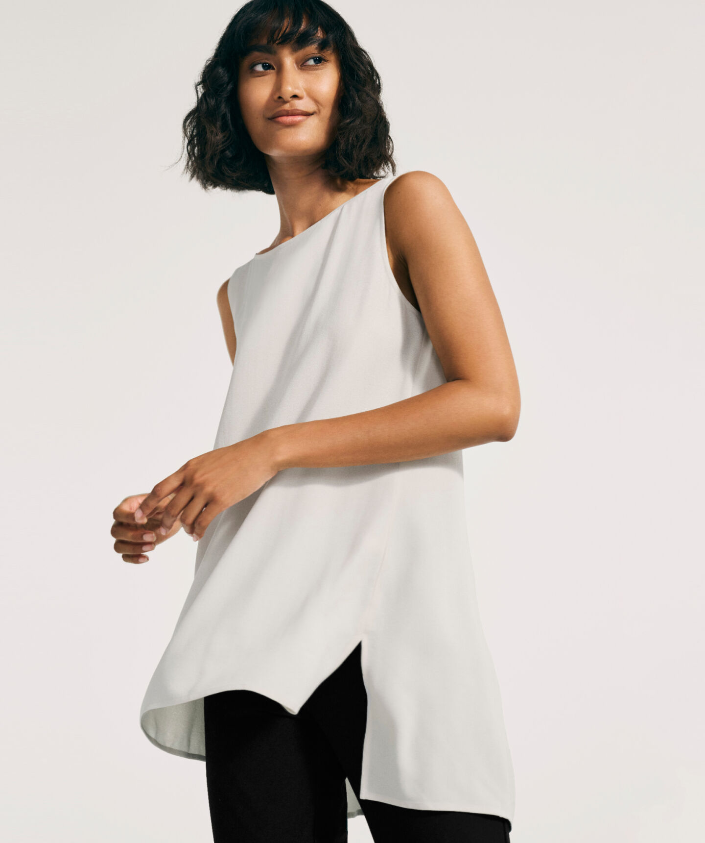 Seated woman dressed in white top. Seated woman dressed in white top.