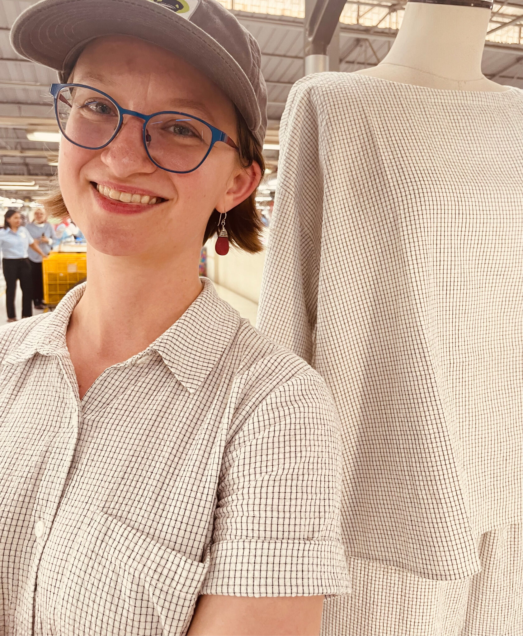 Woman wearing a puckery cotton fabric at the factory where it's being produced. Woman wearing a puckery cotton fabric at the factory where it's being produced.